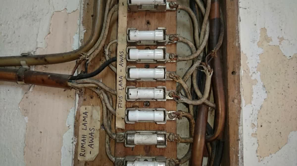 Old electrical wiring and fuse box in a Malaysian home showing signs of outdated wiring