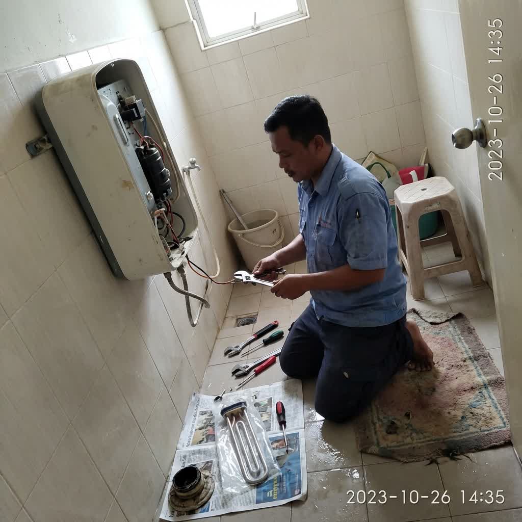 Technician servicing a water heater and replacing the heating element in a Banting home